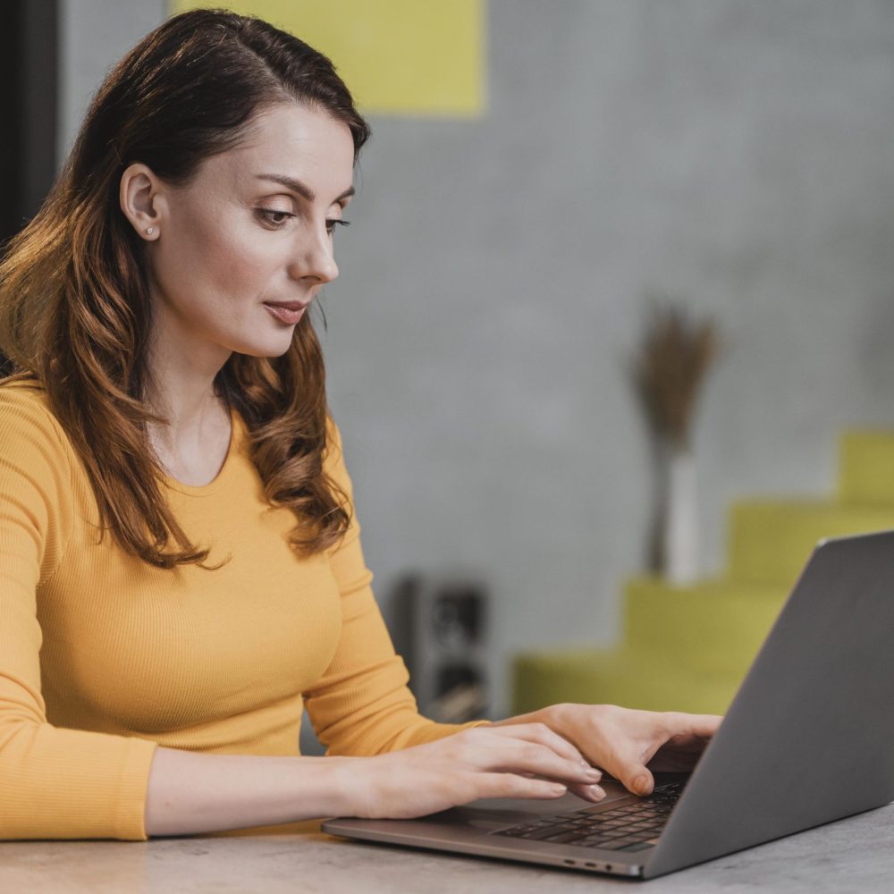 side-view-woman-working-laptop